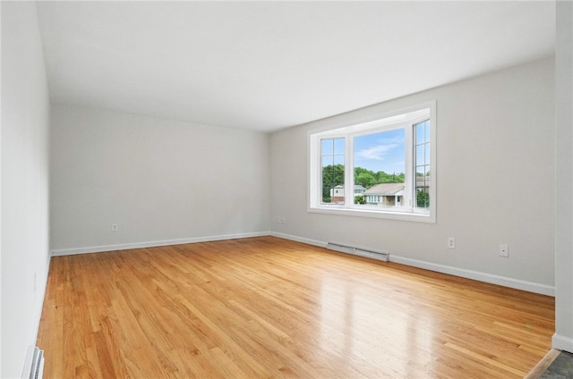 7965 Remington Dr, Mccandless, PA 15237 - spare room featuring baseboard heating, light wood-style flooring, and baseboards