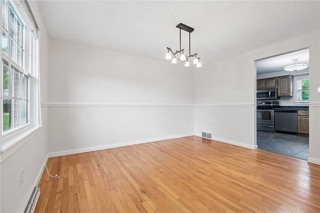 7965 Remington Dr, Mccandless, PA 15237 - unfurnished dining area with baseboard heating, light wood-style floors, a chandelier, and baseboards