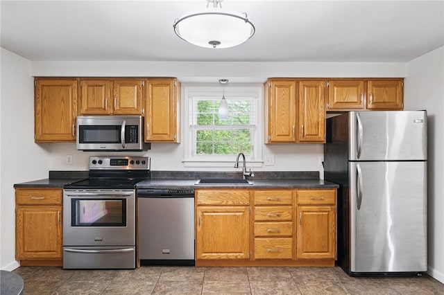 7965 Remington Dr, Mccandless, PA 15237 - kitchen featuring appliances with stainless steel finishes, a sink, dark countertops, and brown cabinets