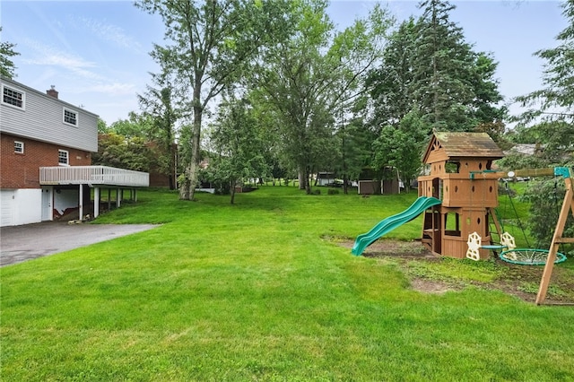 7965 Remington Dr, Mccandless, PA 15237 - view of grassy yard with a playground, driveway, and an attached garage