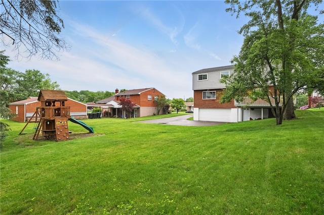 7965 Remington Dr, Mccandless, PA 15237 - view of green lawn with a garage, driveway, and a playground