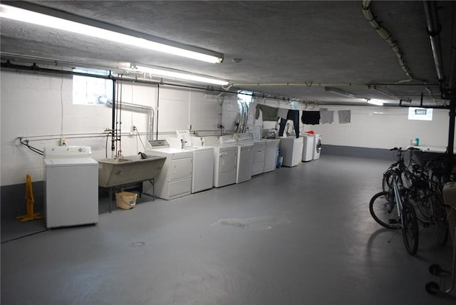 5120 5th Ave Unit 103, Shadyside, PA 15232 - below grade area featuring washing machine and clothes dryer, a sink, and concrete block wall