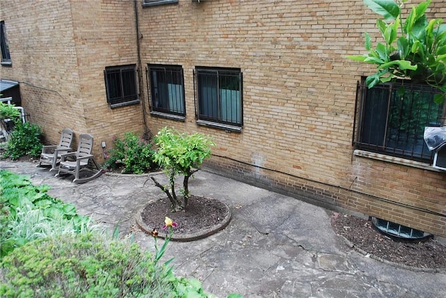 5120 5th Ave Unit 103, Shadyside, PA 15232 - doorway to property featuring a patio area and brick siding