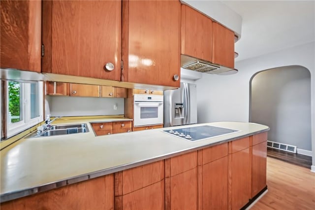19 Ruth St, Hempfield Twp Mer, PA 16125 - kitchen with white oven, stainless steel fridge, a sink, black electric cooktop, and light wood finished floors