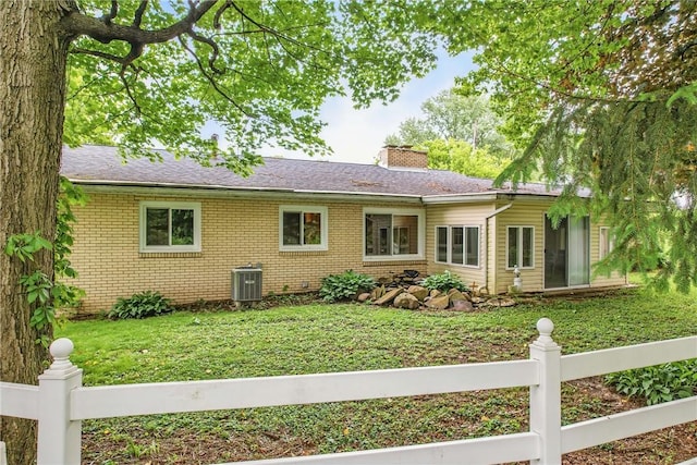 19 Ruth St, Hempfield Twp Mer, PA 16125 - back of property with brick siding, a chimney, and central air condition unit