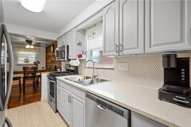 260 Bluemont Dr, West Mifflin, PA 15122 - kitchen featuring appliances with stainless steel finishes, a sink, ceiling fan, and white cabinets