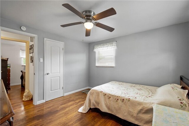 260 Bluemont Dr, West Mifflin, PA 15122 - bedroom with multiple windows, wood finished floors, and baseboards