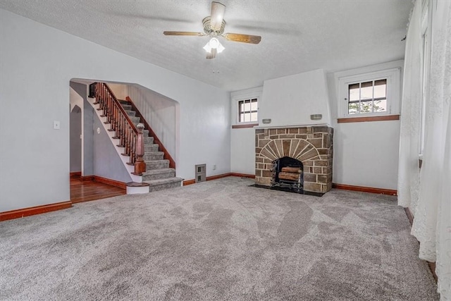 1675 Clairton Rd, West Mifflin, PA 15122 - unfurnished living room with a textured ceiling, stairway, plenty of natural light, carpet floors, and ceiling fan