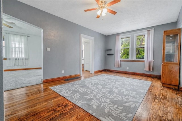 1675 Clairton Rd, West Mifflin, PA 15122 - spare room featuring ceiling fan, wood finished floors, baseboards, and a textured ceiling