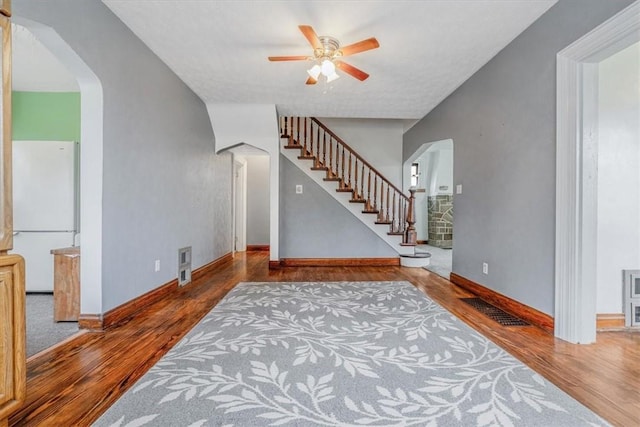 1675 Clairton Rd, West Mifflin, PA 15122 - foyer with wood finished floors, a ceiling fan, arched walkways, baseboards, and stairs