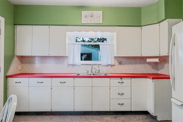 1675 Clairton Rd, West Mifflin, PA 15122 - kitchen featuring a sink, white cabinets, tasteful backsplash, and freestanding refrigerator