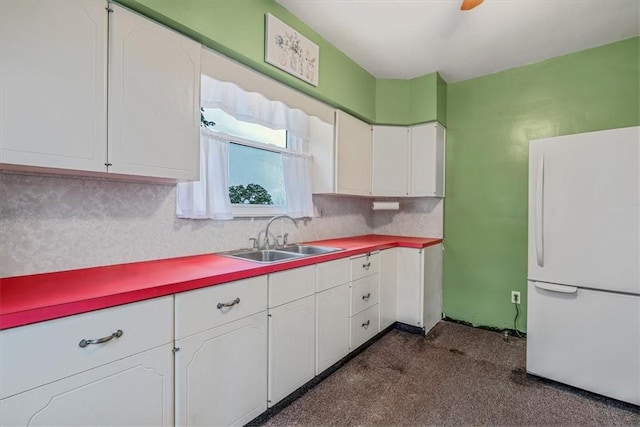 1675 Clairton Rd, West Mifflin, PA 15122 - kitchen with freestanding refrigerator, a sink, white cabinetry, dark carpet, and light countertops