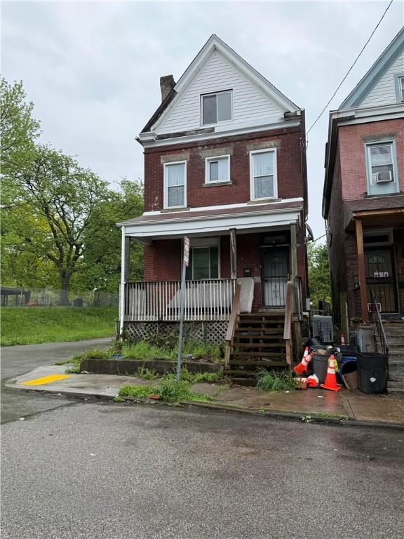 810 N Lang Ave, Homewood-Brushton, PA 15208 - american foursquare style home with a porch, a chimney, and brick siding