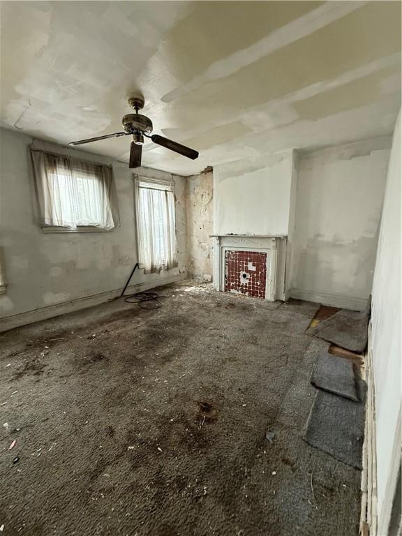 810 N Lang Ave, Homewood-Brushton, PA 15208 - unfurnished living room featuring a ceiling fan and a fireplace
