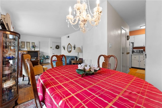 126 Jamestown Ct Unit C, Scott Twp Sal, PA 15216 - dining room featuring a chandelier and wood finished floors