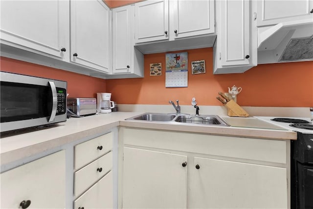 126 Jamestown Ct Unit C, Scott Twp Sal, PA 15216 - kitchen with stainless steel microwave, a sink, light countertops, exhaust hood, and white cabinetry