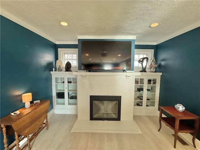 410 E Meyer Ave, New Castle/2Nd, PA 16105 - living area with wood finished floors, healthy amount of natural light, a tile fireplace, ornamental molding, and a textured ceiling