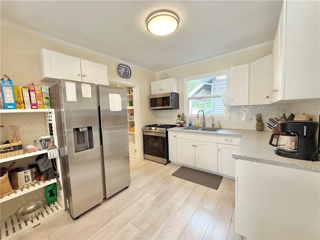 410 E Meyer Ave, New Castle/2Nd, PA 16105 - kitchen featuring stainless steel appliances, crown molding, a sink, light wood-style floors, and light countertops