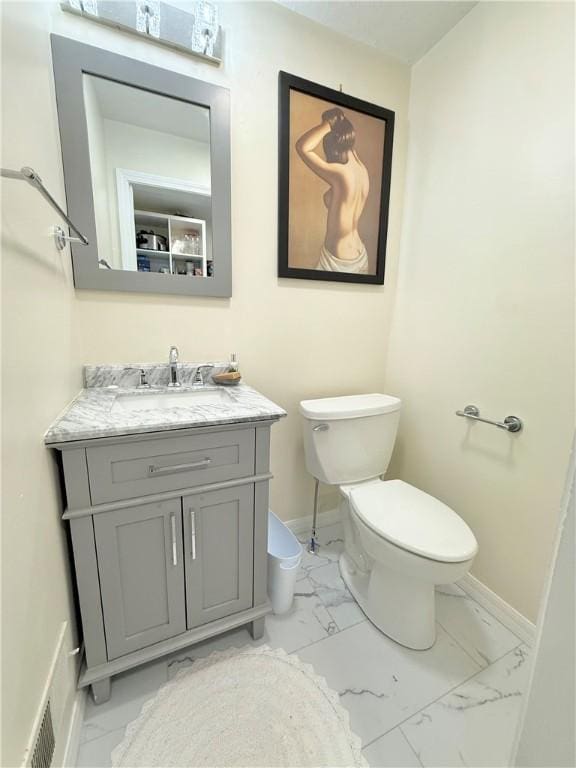 410 E Meyer Ave, New Castle/2Nd, PA 16105 - bathroom featuring marble look tile flooring, toilet, vanity, and baseboards
