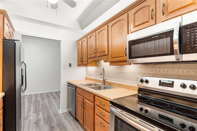 5600 Munhall Rd Unit 201, Squirrel Hill, PA 15217 - kitchen with stainless steel appliances, light wood-type flooring, decorative backsplash, ceiling fan, and light countertops