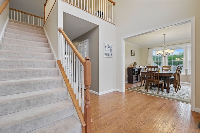 1148 Camarta Dr, Baldwin Boro, PA 15227 - stairs with wood finished floors, a chandelier, baseboards, and ornamental molding