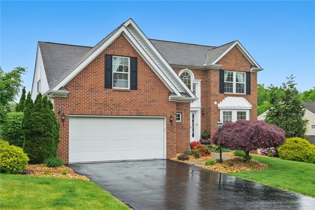 1148 Camarta Dr, Baldwin Boro, PA 15227 - view of front of property with driveway, brick siding, an attached garage, and a front yard