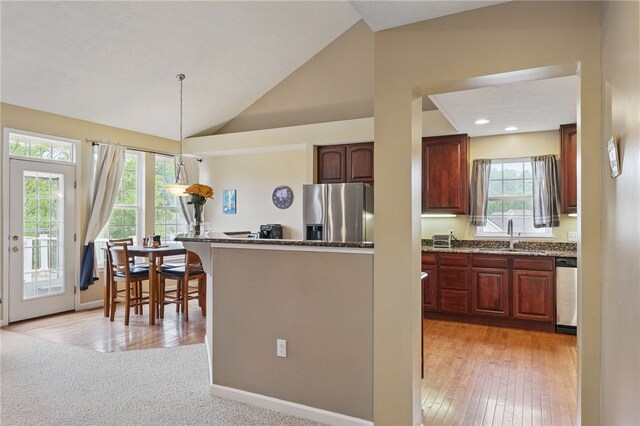 1148 Camarta Dr, Baldwin Boro, PA 15227 - kitchen with stainless steel appliances, a sink, healthy amount of natural light, dark stone countertops, and vaulted ceiling
