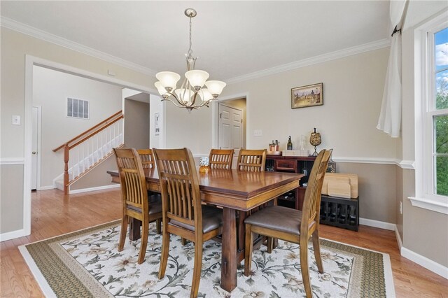 1148 Camarta Dr, Baldwin Boro, PA 15227 - dining area featuring a chandelier, light wood-style floors, stairs, crown molding, and baseboards