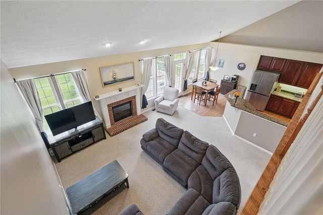 1148 Camarta Dr, Baldwin Boro, PA 15227 - living area featuring light colored carpet, a brick fireplace, vaulted ceiling, and baseboards
