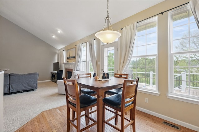 1148 Camarta Dr, Baldwin Boro, PA 15227 - dining room featuring a fireplace, vaulted ceiling, baseboards, and light wood-type flooring