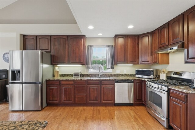 1148 Camarta Dr, Baldwin Boro, PA 15227 - kitchen featuring appliances with stainless steel finishes, a sink, under cabinet range hood, dark stone countertops, and light wood-style floors