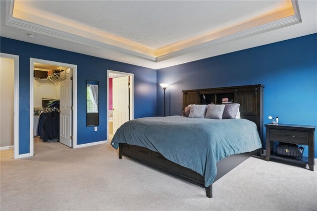 1148 Camarta Dr, Baldwin Boro, PA 15227 - carpeted bedroom featuring a tray ceiling, baseboards, a walk in closet, ensuite bath, and a closet