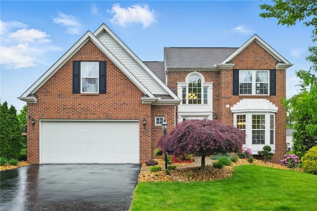 1148 Camarta Dr, Baldwin Boro, PA 15227 - view of front of house with asphalt driveway, an attached garage, a front lawn, brick siding, and roof with shingles
