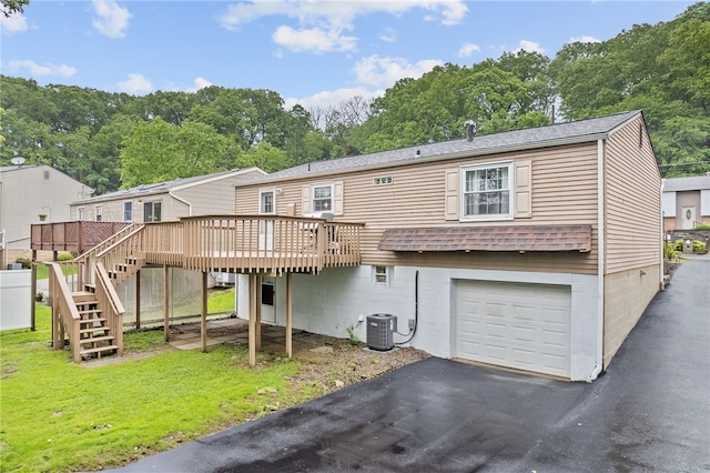 444 Tivoli Rd, Plum Boro, PA 15239 - rear view of house featuring an attached garage, central AC unit, a deck, stairs, and asphalt driveway