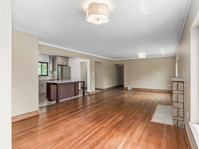 330 Center Grange Rd, Center Twp Bea, PA 15061 - unfurnished living room featuring light wood-style flooring, crown molding, and baseboards
