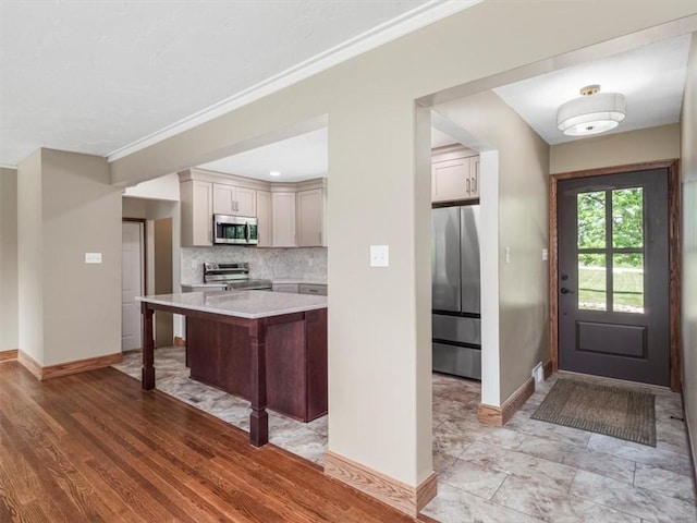 330 Center Grange Rd, Center Twp Bea, PA 15061 - kitchen with appliances with stainless steel finishes, light countertops, baseboards, decorative backsplash, and ornamental molding