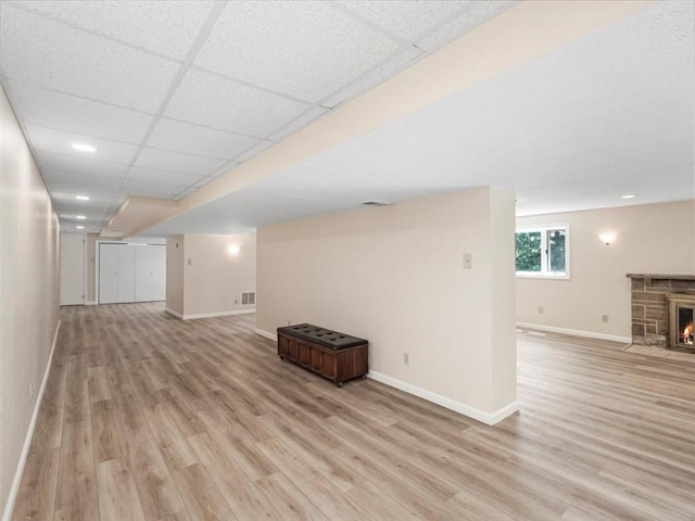 330 Center Grange Rd, Center Twp Bea, PA 15061 - unfurnished living room with baseboards, light wood-type flooring, a stone fireplace, and recessed lighting