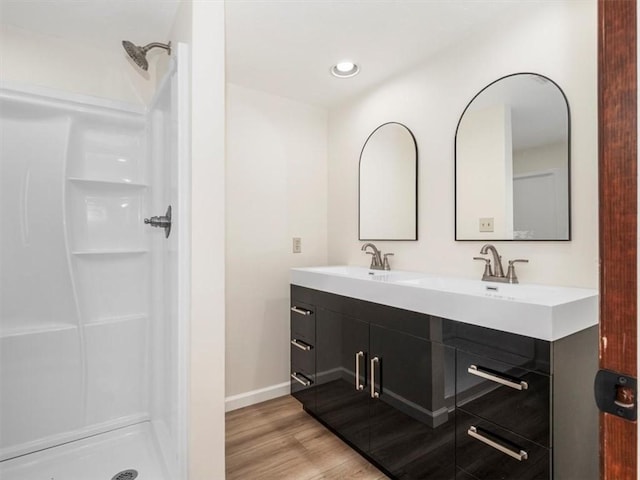 330 Center Grange Rd, Center Twp Bea, PA 15061 - bathroom with double vanity, wood finished floors, baseboards, a shower, and recessed lighting