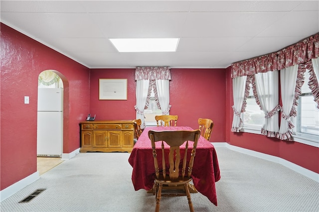 159 2nd Ave, Ross Twp, PA 15229 - dining room with light colored carpet, a textured wall, arched walkways, and baseboards