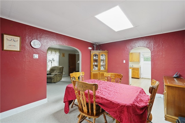 159 2nd Ave, Ross Twp, PA 15229 - carpeted dining space with arched walkways, a textured wall, a drop ceiling, and baseboards