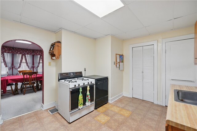 159 2nd Ave, Ross Twp, PA 15229 - kitchen with white gas range oven, a paneled ceiling, dishwasher, baseboards, and light flooring
