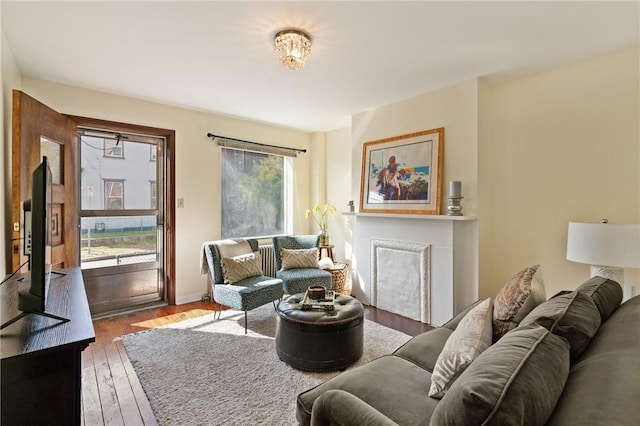 4123 Foster St, Lawrenceville, PA 15201 - living room featuring wood-type flooring, a fireplace, and baseboards