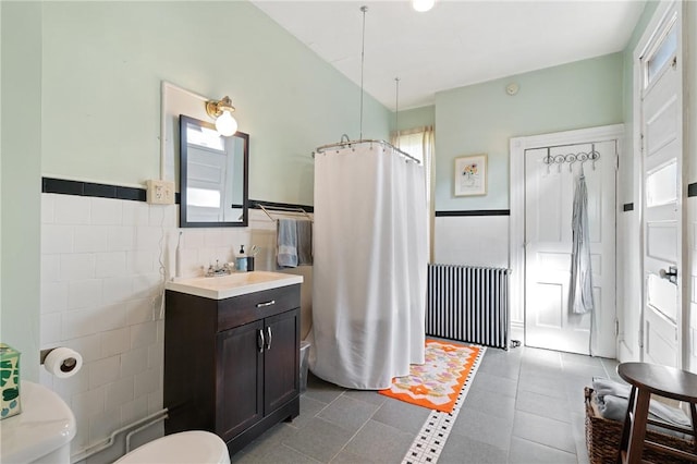 4123 Foster St, Lawrenceville, PA 15201 - bathroom with toilet, tile walls, vanity, a shower with curtain, and wainscoting