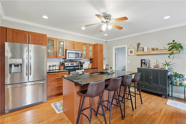 2511 Mission St, South Side, PA 15203 - kitchen with stainless steel appliances, a sink, brown cabinets, dark countertops, and recessed lighting