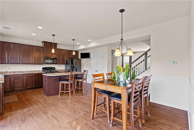 302 Pointe View Dr, Adams Twp, PA 16046 - dining space featuring wood finished floors, wainscoting, stairway, and recessed lighting