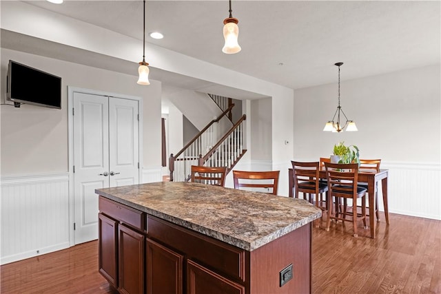 302 Pointe View Dr, Adams Twp, PA 16046 - kitchen with wainscoting, wood finished floors, a kitchen island, and decorative light fixtures