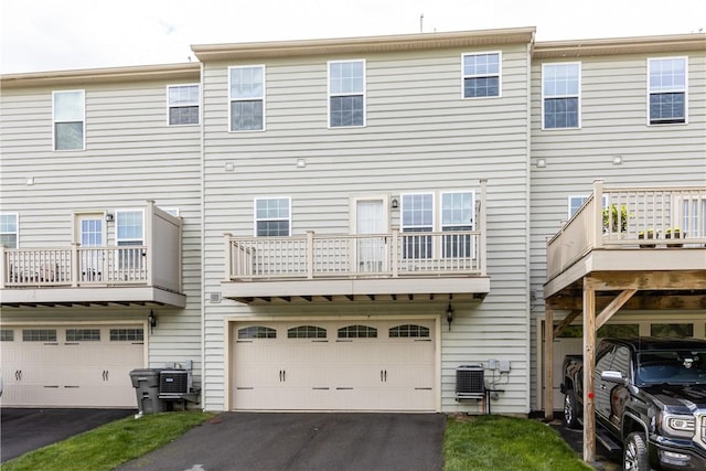 302 Pointe View Dr, Adams Twp, PA 16046 - rear view of house with central AC unit, asphalt driveway, and a garage