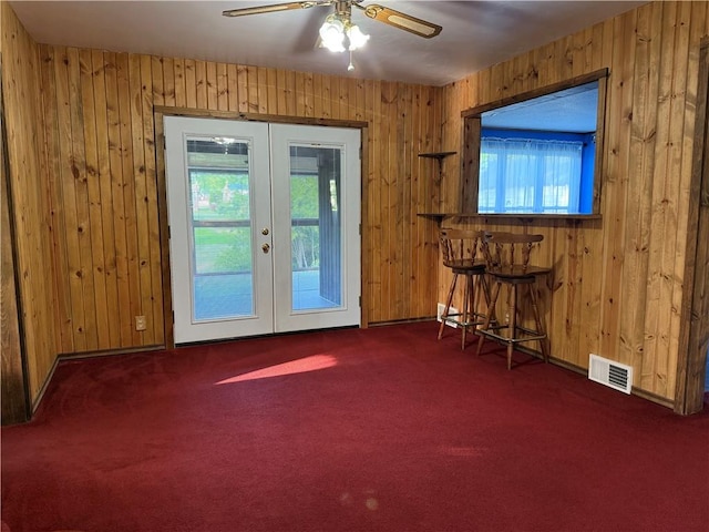 2225 Pleasantview Dr, Manor Twp, PA 16226 - entryway featuring french doors, dark colored carpet, wood walls, ceiling fan, and baseboards