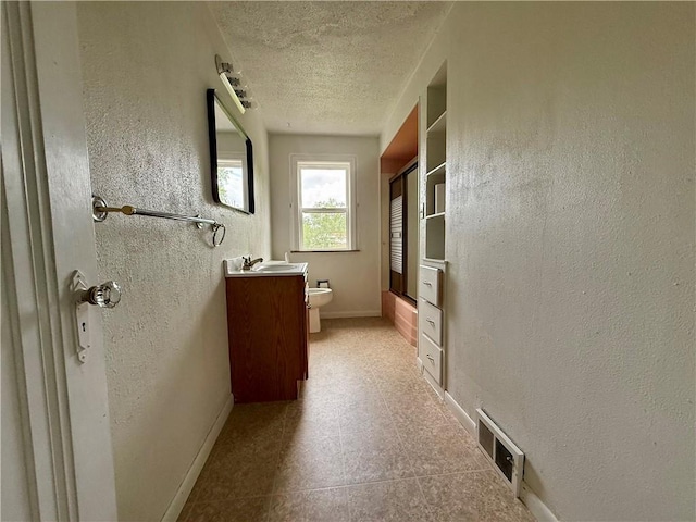 2225 Pleasantview Dr, Manor Twp, PA 16226 - full bathroom with vanity, toilet, a textured ceiling, shower / bath combination with glass door, and baseboards