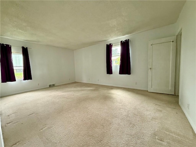 2225 Pleasantview Dr, Manor Twp, PA 16226 - unfurnished room featuring healthy amount of natural light, light colored carpet, a textured ceiling, and baseboards